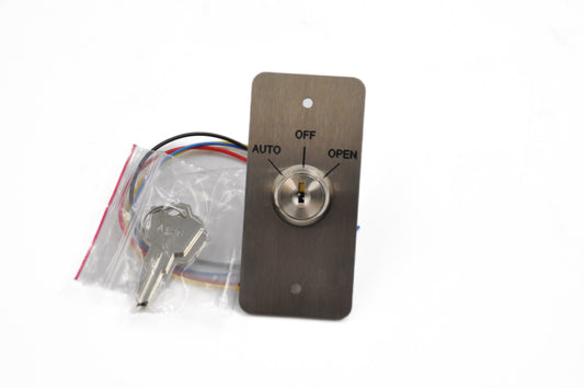 Front view of a 3-Position Key Switch with 'Auto', 'Open', and 'Off' settings, stainless-effect engraved plate, and two keys included