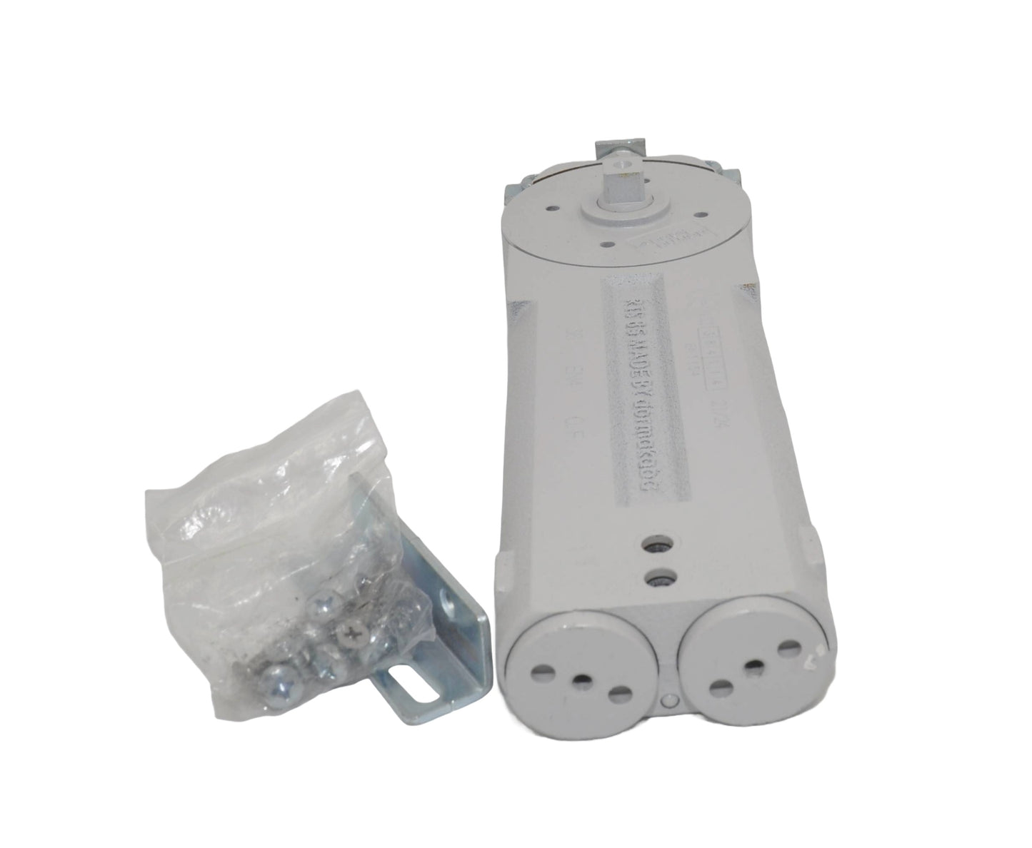 A view of a dormakaba RTS85 Transom Door Closer with its packaging, predominantly grey in colour. On a white background.