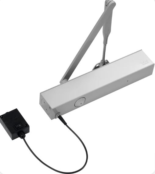 A view of a Dorma TS73 EMF Electro Magnet 24v DC Door Closer with black wire and black square box, on a white background.