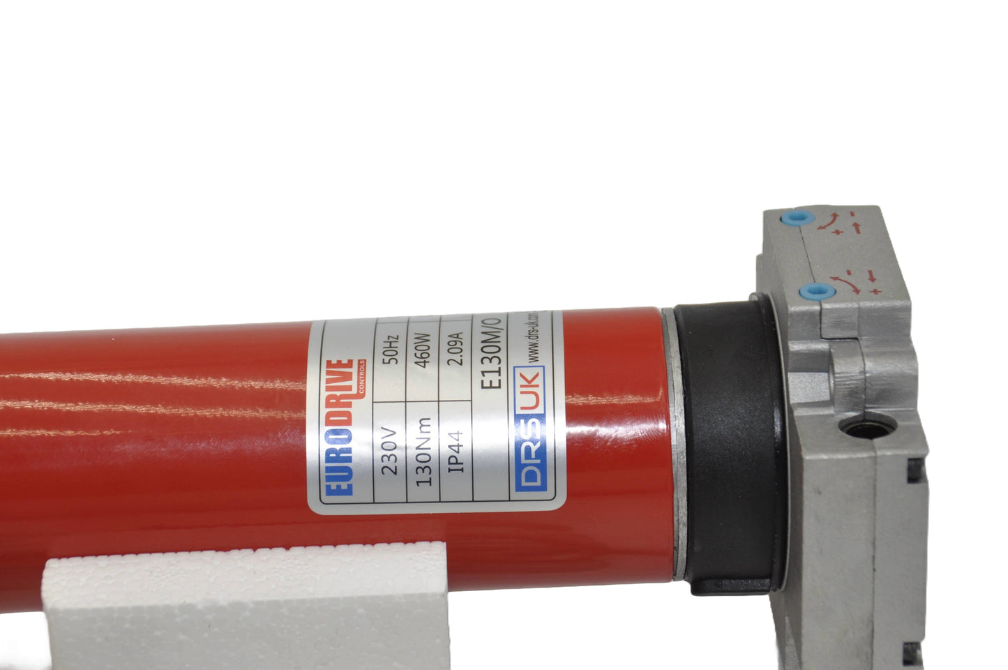 Part of a E130nm Motor in red with a label in grey, blue and red. On a white background.