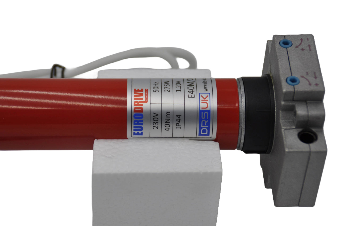 A red tubular motor for roller shutters, with wires and a grey label with blue, black and red text. On a white background