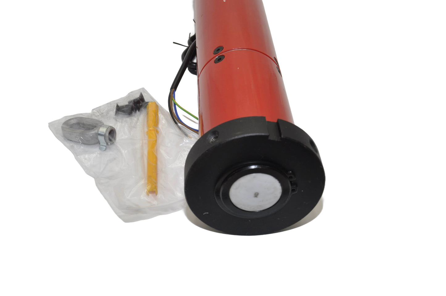 Close-up of a motor with accessories in a clear plastic packaging. On a white background.