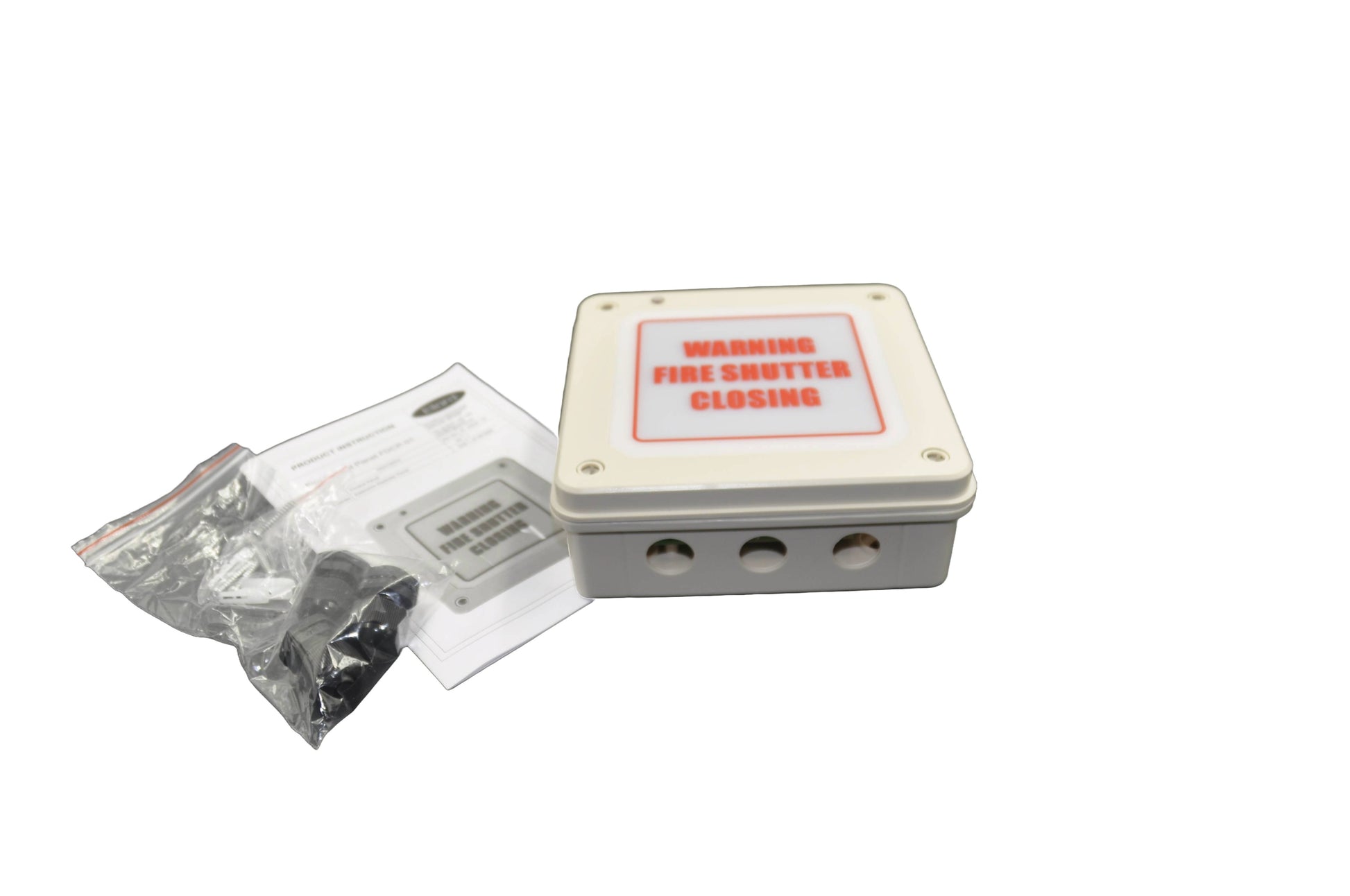 A top view of a Rectangular metal box with 'WARNING FIRE SHUTTER CLOSING' label and components in clear packaging, on a white background