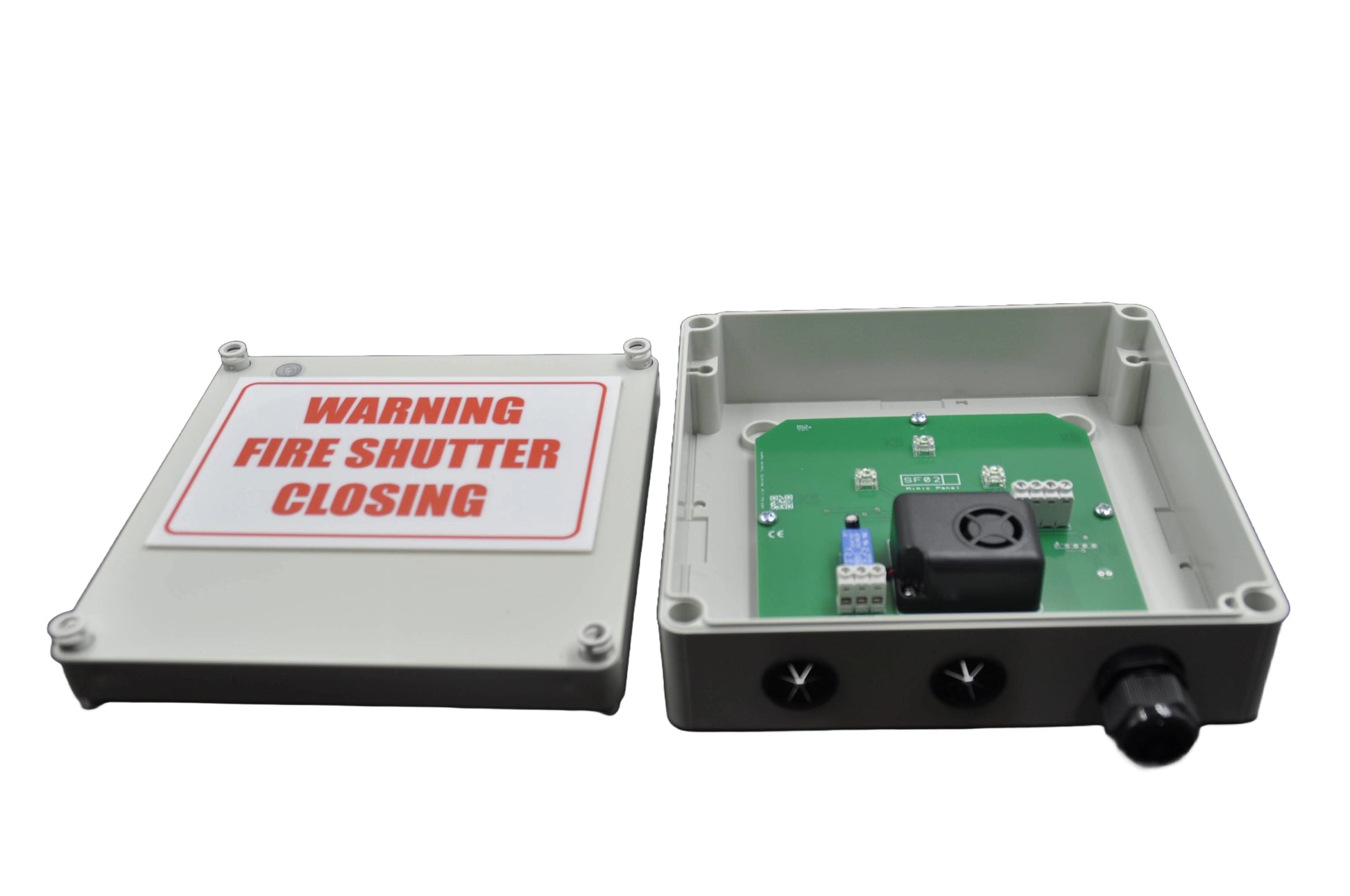 Fire shutter control box open with white label with "warning fire shutter closing" on one half and components showing in the inside of the other half  on a white background