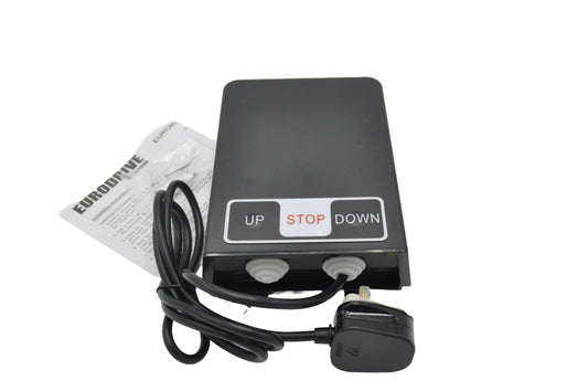 A Eurodrive roller shutter control unit with a black surface, featuring buttons labeled 'UP', 'STOP', and 'DOWN', accompanied by a programming manual. On a white background.