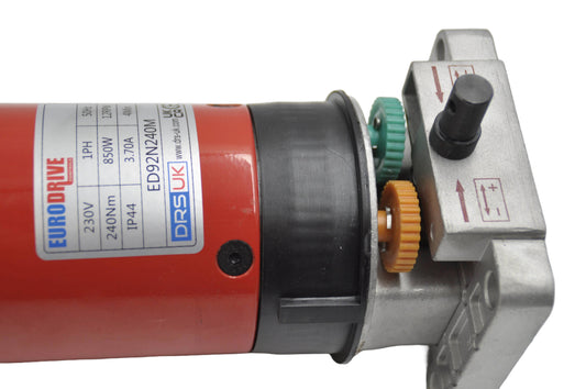 An industrial motor for roller shutters, predominantly red and black in color with visible branding and model information. On a white background.