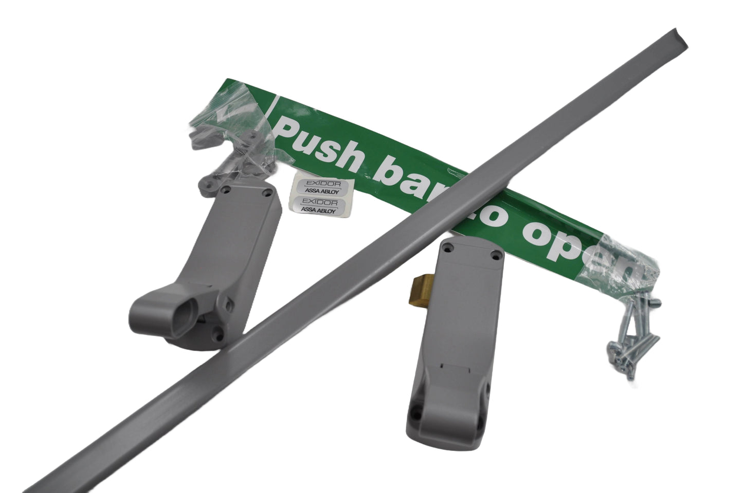 A silver Exidor single panic latch with a push bar, fixings in a plastic with a green sign with white lettering that reads Push bar to open, designed for emergency exit applications in buildings. On a white background.