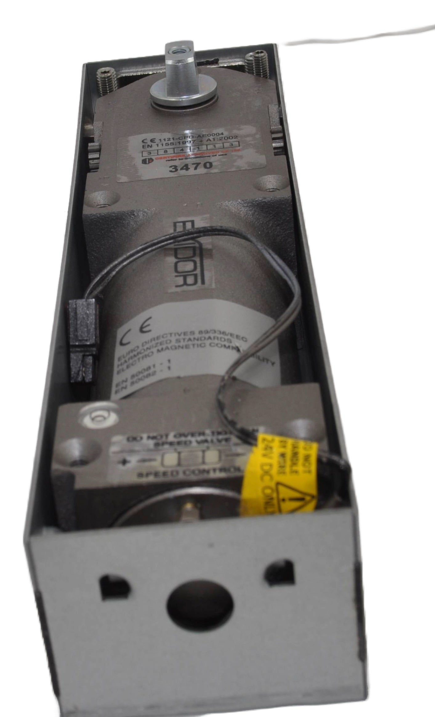 Exidor 3470 EMAG Floor Spring, an electromagnetic hold-open floor closer for heavy-duty doors, showing the mechanism within a metal housing box. On a white background.