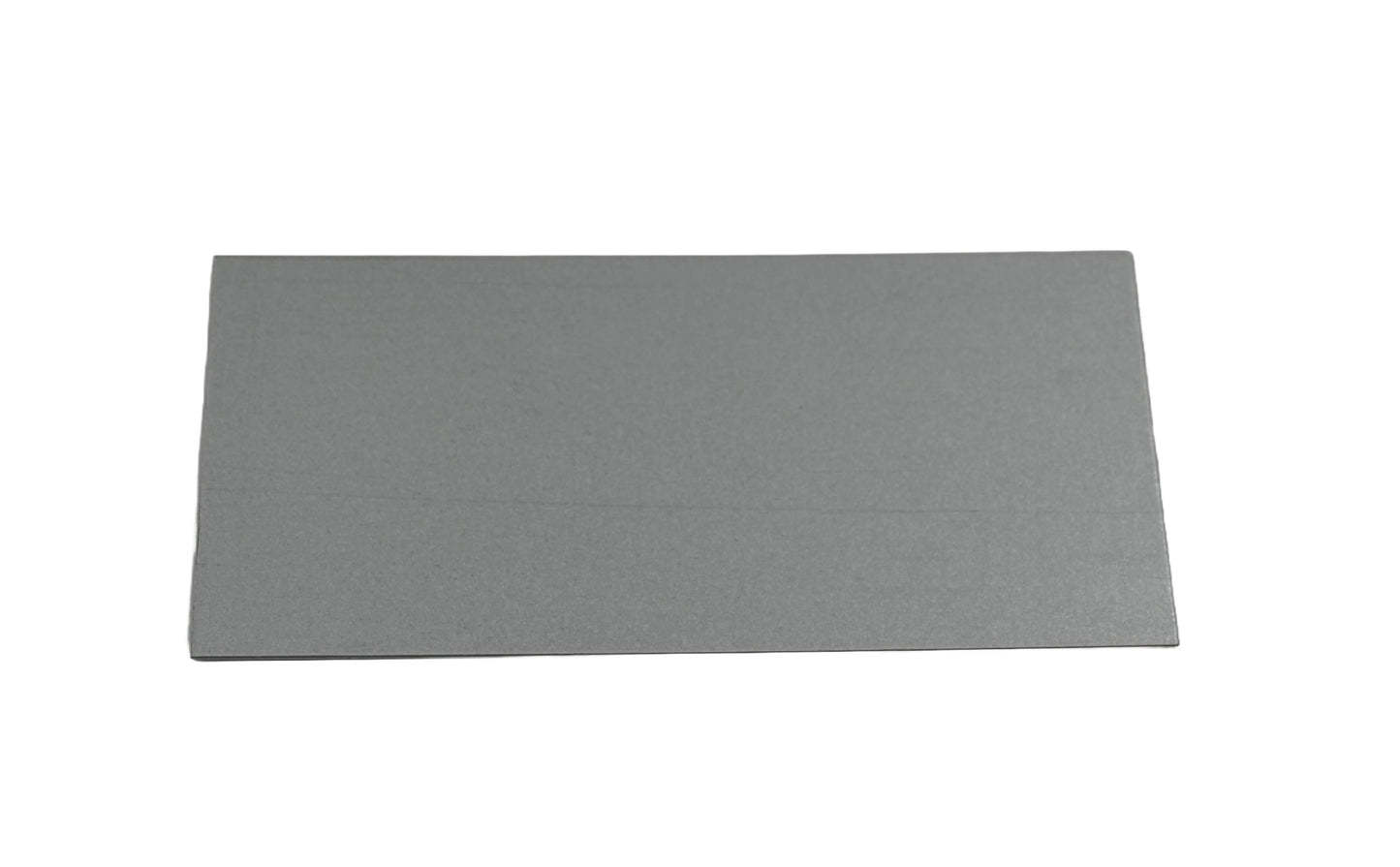 A grey galvanised metal blanking plate with a rectangular shape. On a white background