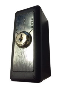 An image of a Black and metal keyswitch with black writing and a  keyhole on a white background