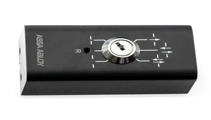 Assa Abloy - Program Selector PSK-6U, consisting of a Black electronic device with a dial and 'Assa abloy' branding on a white background