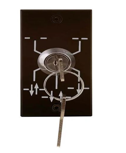 Assa Abloy key switch which consists of a black plate with white lines and arrows with key hole and 2 keys, on a white background.