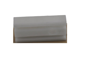 A view of a Besam breakout shoe which consists of a rectangular piece of plastic.  On a white background.