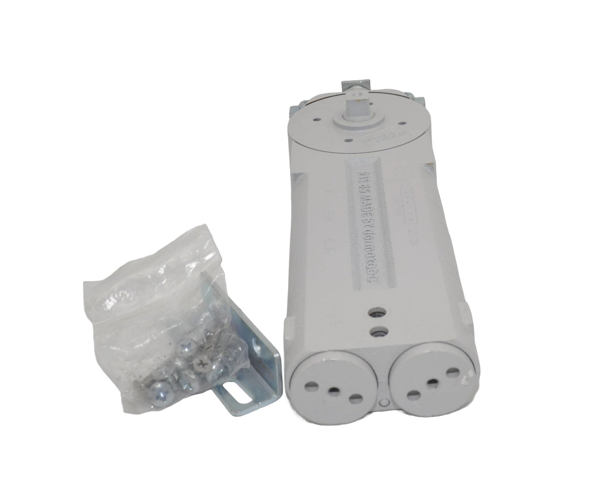 A view of a dormakaba RTS85 Transom Door Closer with its packaging, predominantly grey in colour. On a white background.